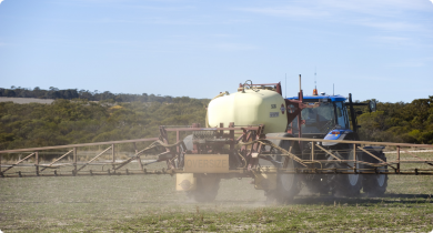 Boom spray applying chemical over pasture paddock