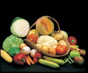 Display of different fruit and vegetables in a basket, including rockmelon, carrots, capsicum, cauliflower, tomato,apples, onions, bananas, beans, potatoes, lettuce and sweet corn