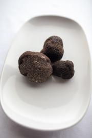 The external surface of the black truffle is rough and pebbly, the internal is blackish with white veins
