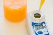 Digital refractometer measuring percentage Total Soluble Solids of citrus juice