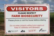 A sign on the farm gate asking visitors to respect farm biosecurity