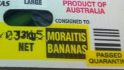 A box of bananas that have been inspected and stamped with a sticker saying passed quarantine
