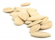 Pumpkin seed, which is a pale colour and an elongated oval shape.
