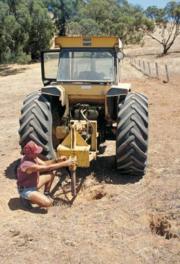 Tractor-mounted ripper for rabbit warren destruction.