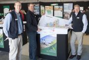Two Geographic Information Services staff hold a map of Merredin Shire at the DAFWA display at the Dowerin Field Day.