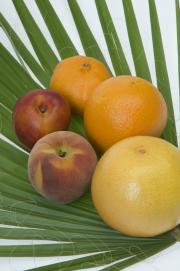 Citrus and stone fruit on a palm leaf