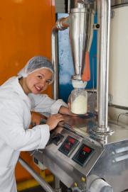 Food technologist working on food manufacturing equipment