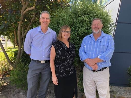 Consultation leads Peter Gray, Beth Green and Brad McCormick Peter Gray, Beth Green and Brad McCormick standing in a line in front of an office building