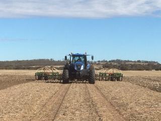 Tractor seeding in a dry paddock.