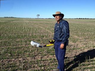 DAFWA research officer Dr Raj Malik checks plant growth with a GreensSeeker machine, at Cunderdin, as part of a research project to improve the value of oat production in low rainfall areas.