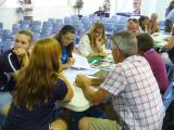 Group of people around a table looking at documents