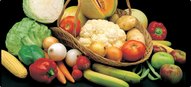 Display of different fruit and vegetables in a basket, including rockmelon, carrots, capsicum, cauliflower, tomato,apples, onions, bananas, beans, potatoes, lettuce and sweet corn