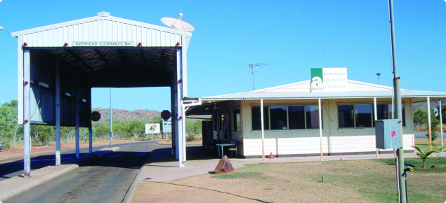 The Kununurra quarantine checkpoint, a white building alongside a large, tall, open backed shed used for inspections.