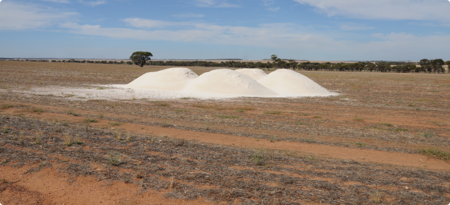 Agricultural lime dumped in a paddock ready to be spread. 