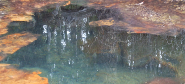 Picture showing clear blue green coloured water caused by dissolved aluminium