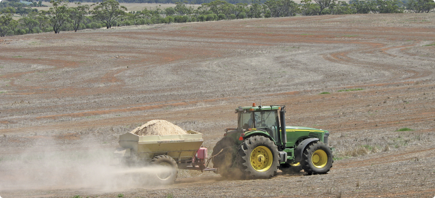 Surface application of agricultural lime using a tow-behind spreader 