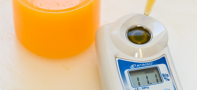 Digital refractometer measuring percentage Total Soluble Solids of citrus juice