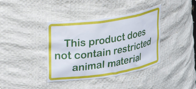 Bag of sheep pellets with a label indicating the feed does not contain restricted animal material.