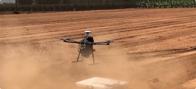 A drone being launched in a field.