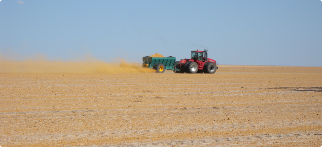 Photograph of clay spreader in action across a paddock susceptible to wind erosion