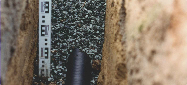 pipe and blue metal in the base of a trench