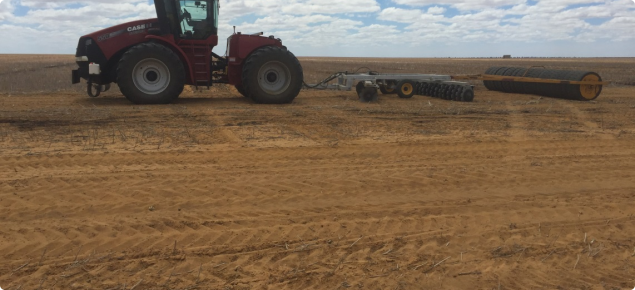 Tractor towing a set of offset discs and tyre roller