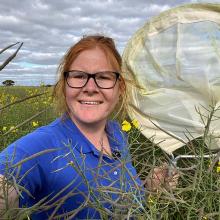 Woman in paddock holding net