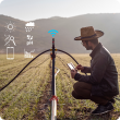 Farmer checks operations on smart device