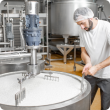 Cheese manufacturer mixing milk in