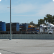 Trucks about to load cattle at a saleyard ramp