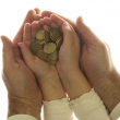 two hands holding coins
