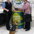 Quarantine WA officer Louise Smith with detector dog Jackson and off-duty officer Lexy Martin demonstrate use of the amnesty bins at Perth domestic airport. 