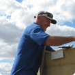 Katanning Research Facility technical officer Geoff Cox installs the tank sensor on the water tank.